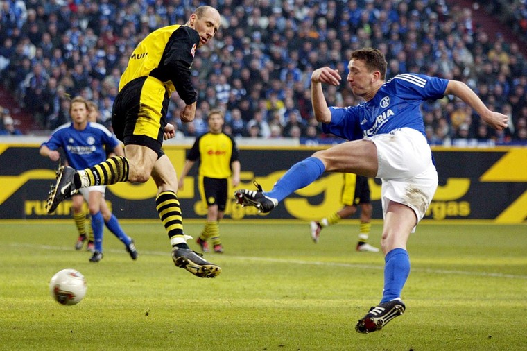 Marco van Hoogdalem haalt uit tijdens de Kohlenpott Derby tegen Borussia Dortmund. Jan Koller deinst terug.