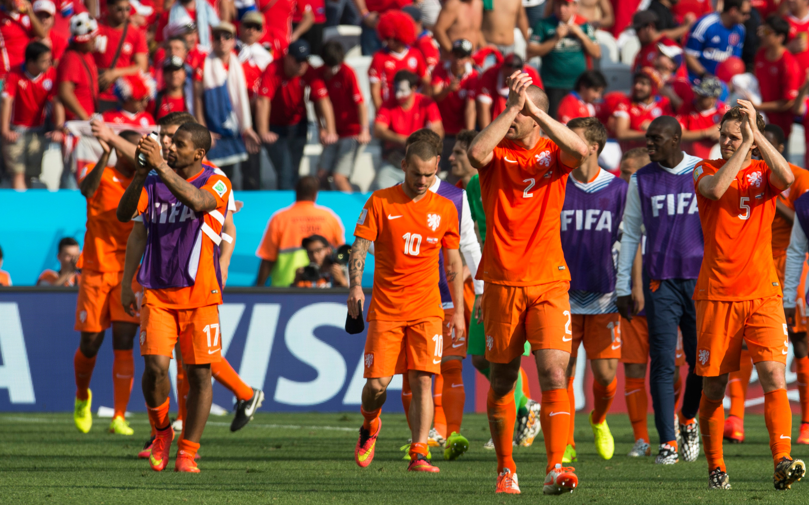 De spelers van het Nederlands elftal stappen na de wedstrijd tevreden van het veld en bedanken de meegereisde Oranje-supporters.