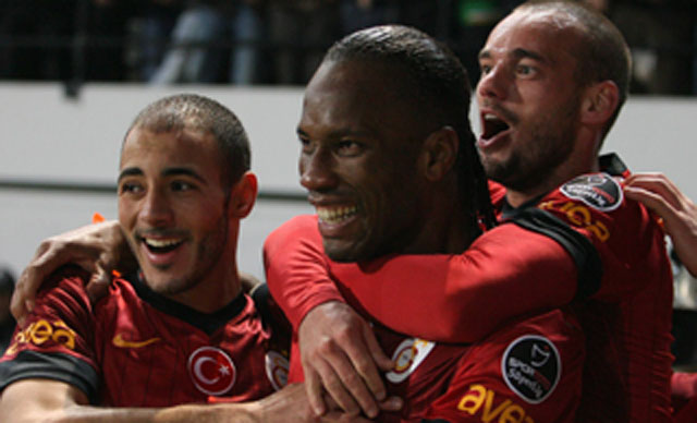 Wesley Sneijder en Nordin Amrabat bejubelen samen met Didier Drogba een Galatasaray-goal.